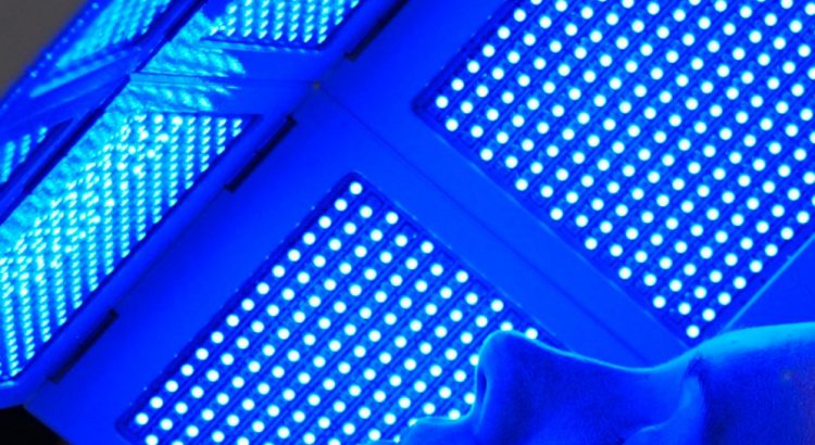 Picture of woman layiong under blue LED light therapy